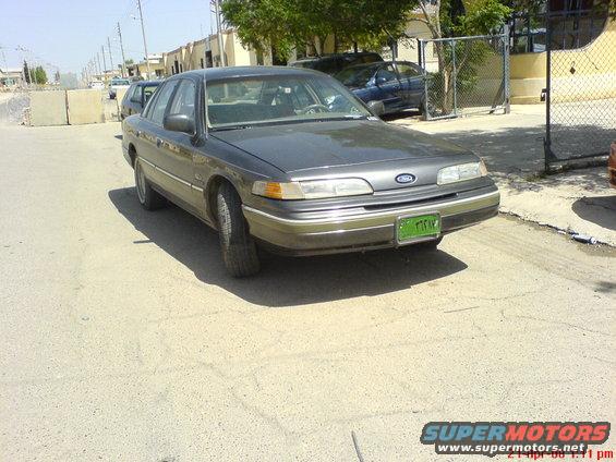 1992 Ford Crown Victoria front view, dark gray sedan with green license plate