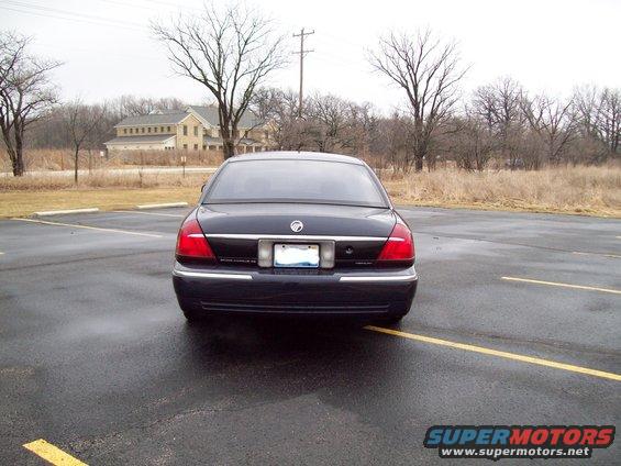 Dark sedan rear view, chrome trim, taillights