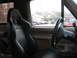1990 Ford Bronco - The interior of a 1990 Ford Bronco features racing seats and a steering wheel, with other vehicles visible through the window.