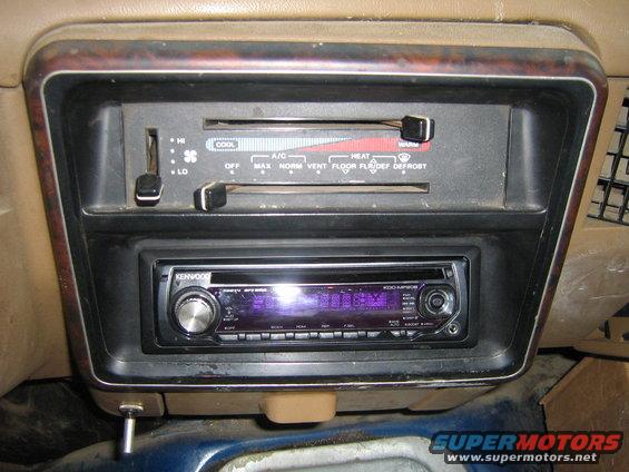 Car interior showing climate controls with HI/LO and COOL/HEAT settings, and an aftermarket Kenwood stereo below