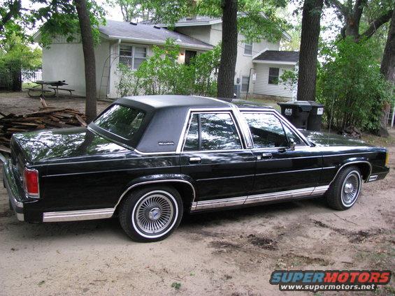 Black 1988 Ford Crown Victoria parked outside a house