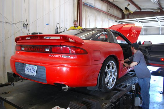 Red 1991 Mitsubishi 3000GT VR-4 on a lift with hood and door open