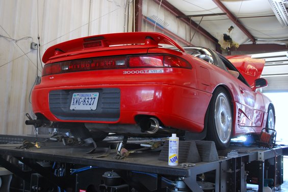 Red 1991 Mitsubishi 3000GT VR-4 on a dynamometer, rear view