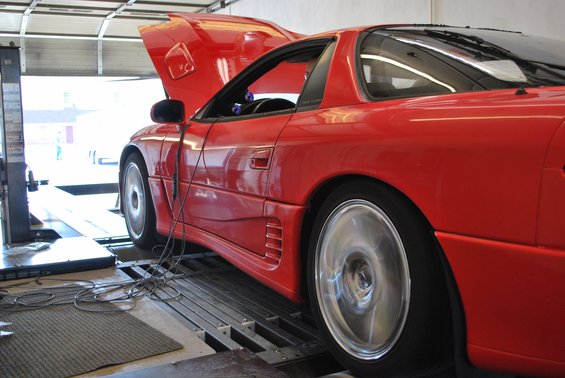 1991 Mitsubishi 3000GT on a dynamometer, hood up, wheels spinning