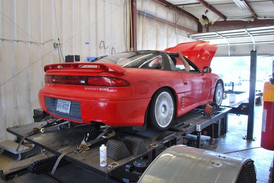 Red 1991 Mitsubishi 3000GT on a dynamometer, rear view. License plate is KVG-8527