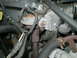 1996 Ford Bronco - Close-up view of various engine parts, including hoses, wires, and metal components.