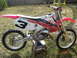 2006 Honda CBR-RR - Side view of a red and white 2006 Honda CBR-RR dirt bike.