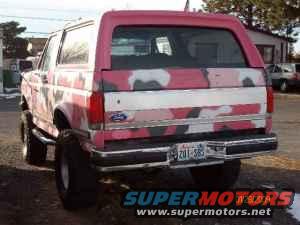 Pink camouflage Ford Bronco rear view, dirty, with aftermarket bumper and license plate