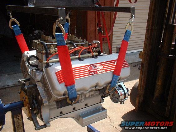 Ford 427 SOHC engine with dual carburetors, suspended by straps