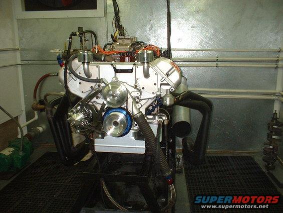 Engine on a test stand with exhaust headers and intake manifold