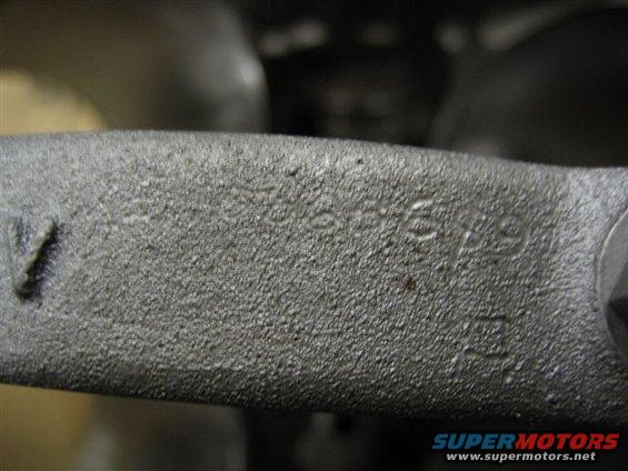 Close-up of a metal part with stamped numbers, possibly a casting number or VIN fragment
