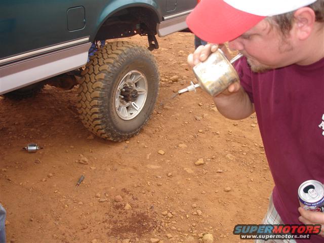 Green truck side with large off-road tire and chrome trim