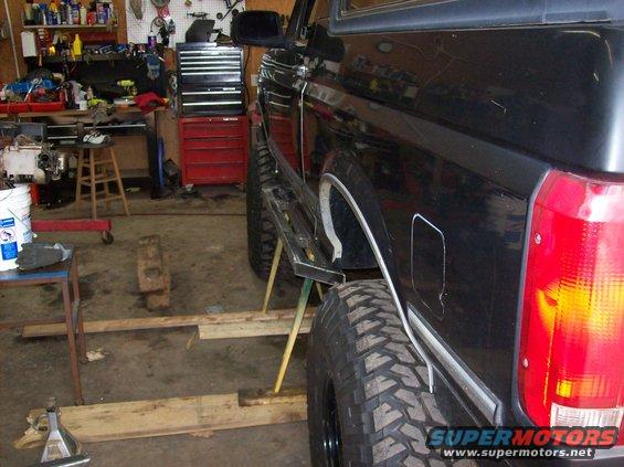 1992 Ford Bronco side view showing running boards and large tires in a garage