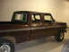 1979 Ford F-250 - Side view of a brown four-door pickup truck parked indoors.