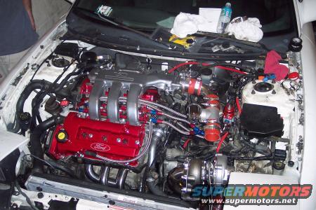 White 1994 Ford Probe engine bay with red Ford valve covers and turbocharger