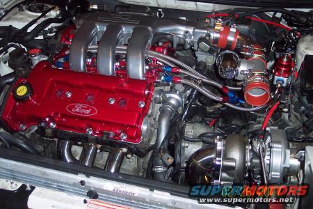 Engine bay with red Ford valve cover and turbocharger