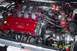 1994 Ford Probe - Customized engine bay a red Ford valve cover and a prominent turbocharger installation.