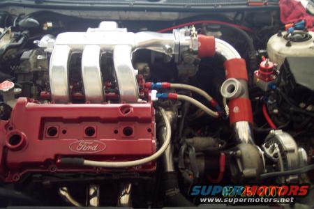 Close-up of a Ford engine with a turbocharger and custom intake manifold