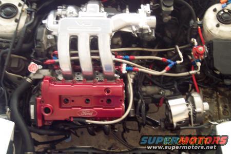 Engine bay with red Ford valve cover and V6 intake manifold
