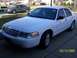 2008 Ford Crown Victoria - White 2008 Ford Crown Victoria parked on a suburban driveway with another car visible.