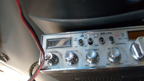 Close-up of a Cobra 25 LTD CB radio with volume, squelch, and mic gain knobs