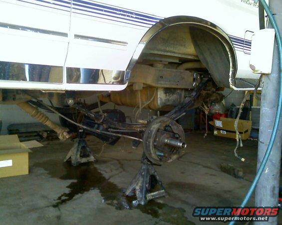1996 Ford Bronco rear axle assembly on jack stands, undergoing repair