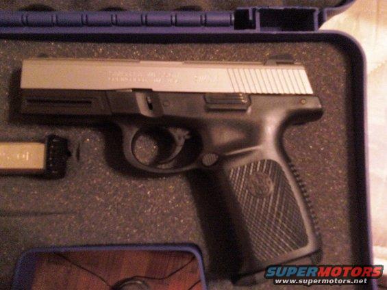Semi-automatic pistol with magazine in a blue case. Text on slide is visible