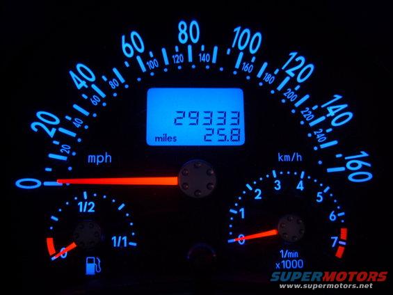 Car dashboard with speedometer, tachometer, fuel gauge, and digital odometer showing 29333 miles