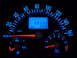 2003 Volkswagen Beetle - The illuminated dashboard displays the vehicle's speed, engine RPM, fuel level, and total mileage.