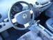 2003 Volkswagen Beetle - Interior view of a 2003 Volkswagen Beetle, highlighting the dashboard and driver's controls.