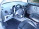 2003 Volkswagen Beetle - The interior of a 2003 Volkswagen Beetle, black leather seats and a grey dashboard.