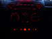 2003 Volkswagen Beetle - The interior dashboard of a vehicle glows with red illumination on its controls and buttons.