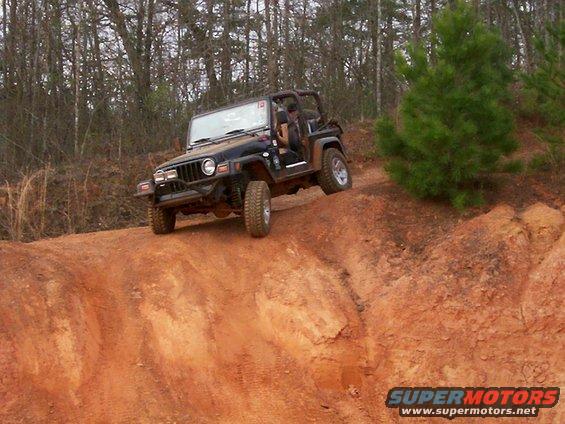 Black Jeep Wrangler TJ on dirt trail