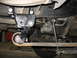 1995 Ford C-350 (Centurion Conversions) - Custom suspension part installation on a vehicle's undercarriage.