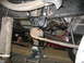 1995 Ford C-350 (Centurion Conversions) - Close-up view of the undercarriage, focusing on suspension parts and hardware.