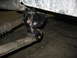 1995 Ford C-350 (Centurion Conversions) - This photo shows a close-up of a vehicle's suspension system, focusing on a bracket and leaf spring.