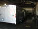 1995 Ford C-350 (Centurion Conversions) - An enclosed cargo trailer is parked inside a building with a wet floor.