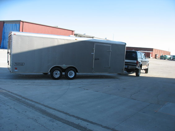 1992 Ford Bronco towing a silver Haulmark trailer