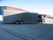 1995 Ford C-350 (Centurion Conversions) - A 1992 Ford Bronco is seen towing a large silver Haulmark trailer.