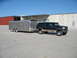 1995 Ford C-350 (Centurion Conversions) - This 1995 Ford C-350 Centurion Conversions SUV is shown from a three-quarter front view while towing a large silver trailer.