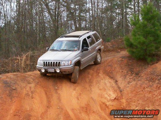 Silver Jeep Grand Cherokee on dirt trail