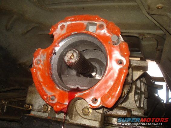 Vehicle transfer case with orange sealant and splined shaft.