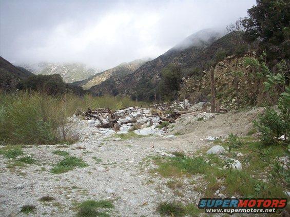 mountain valley with debris and fog on the peaks