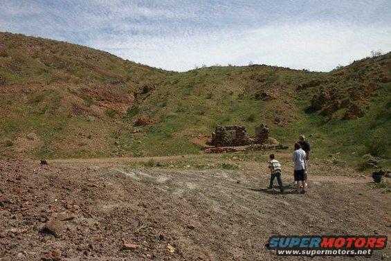Desert landscape with ruins and people