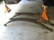 1991 Ford Bronco - Leaf springs removed from a vehicle and placed on jack stands for maintenance or replacement.