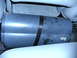 2005 Ford F-250 - A Bazooka EL subwoofer tube is visible between the seats of a vehicle.