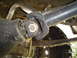 1978 Ford Bronco - Close-up view of a vehicle's driveshaft U-joint and differential, highlighting mechanical components.