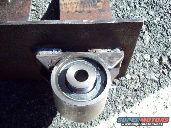 Close-up of a metal suspension component with visible welds