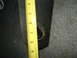 1978 Ford Bronco - A yellow measuring tape is shown against a dark, textured surface with a circular hole.