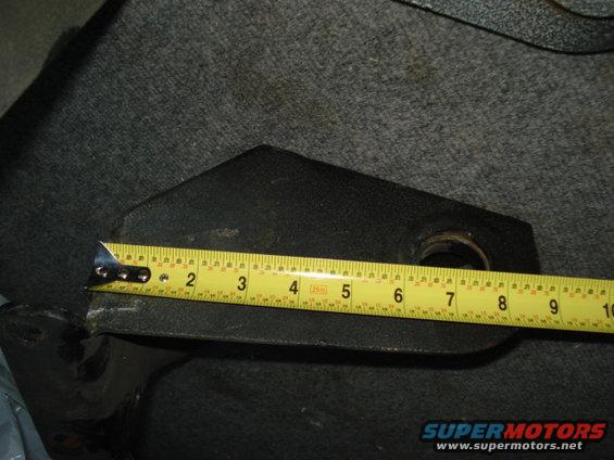 Metal part with measuring tape showing approximately 7 inches